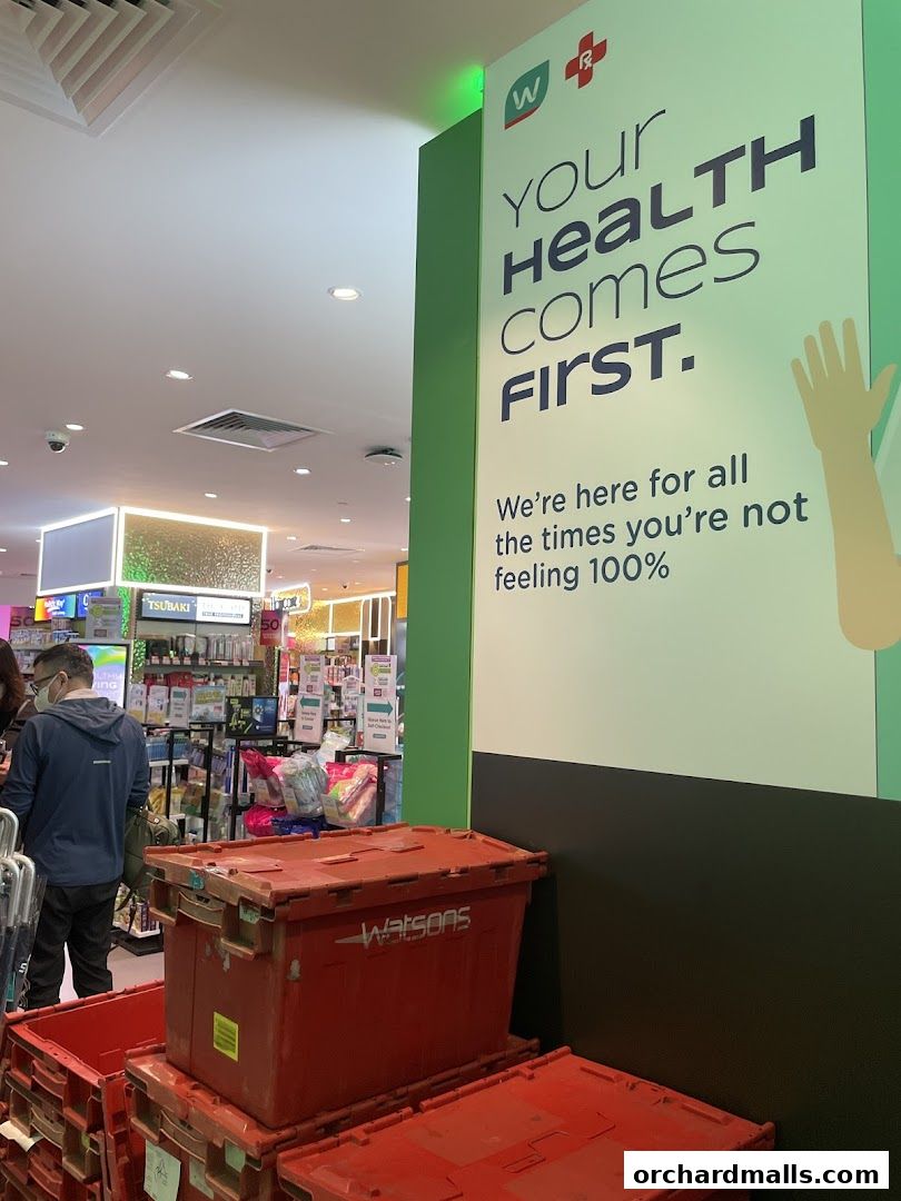 Watsons store interior with a large sign emphasizing health and red storage bins.