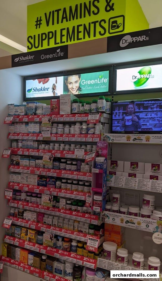 A wide selection of vitamins and supplements displayed on shelves with prominent 20% off sale signs.