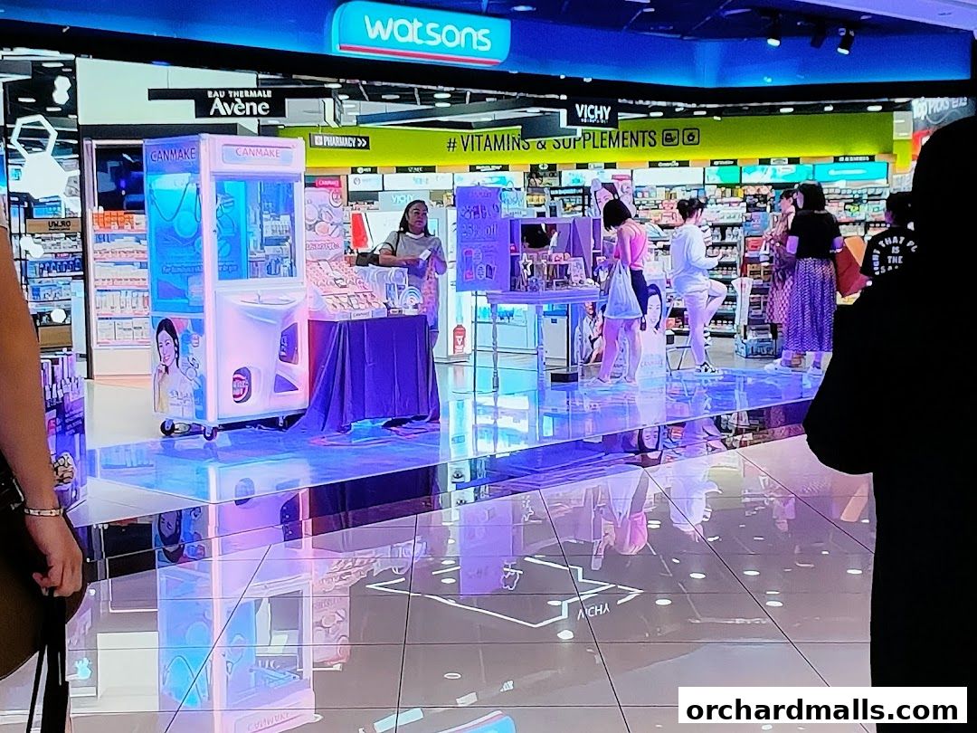 Watsons store interior with beauty products, a claw machine, and shoppers.