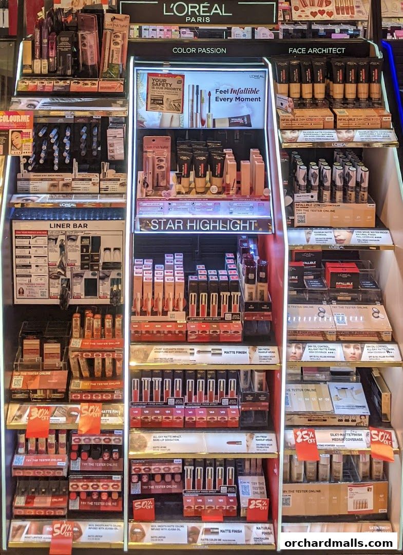 A display of L'Oréal makeup products including foundation, lipstick, and eyeliner.