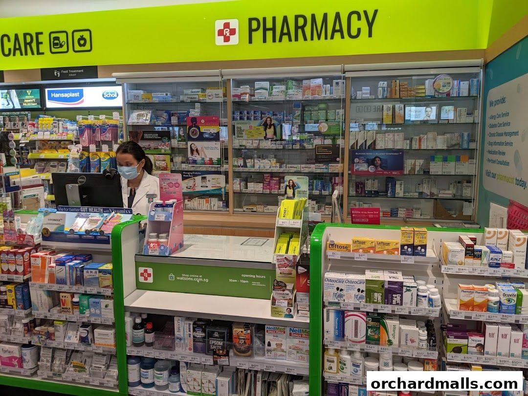 A Watsons pharmacy counter with a pharmacist and shelves stocked with health and wellness products.