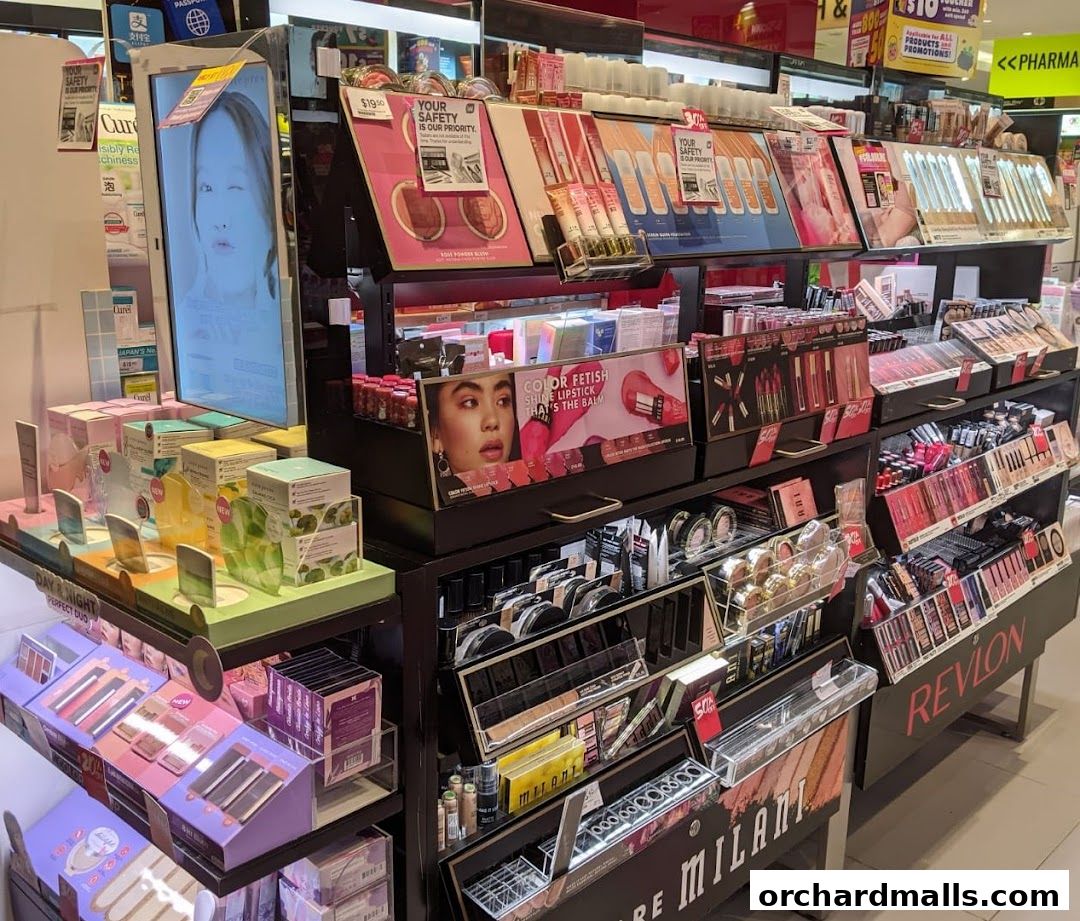 A display of various makeup products including lipsticks, foundations, and skincare items.