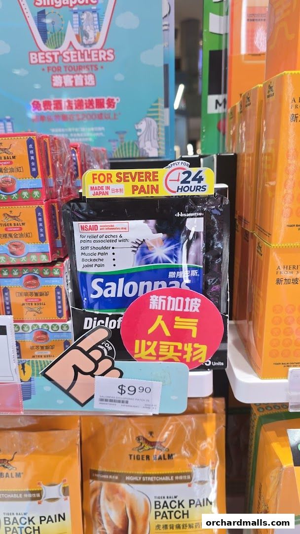 A display of pain relief patches and balms, including Salonpas and Tiger Balm products.