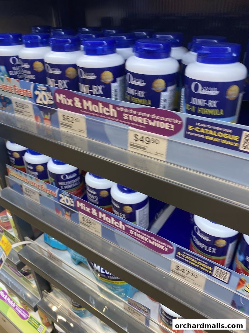 Shelves stocked with various health supplements in blue and white bottles.