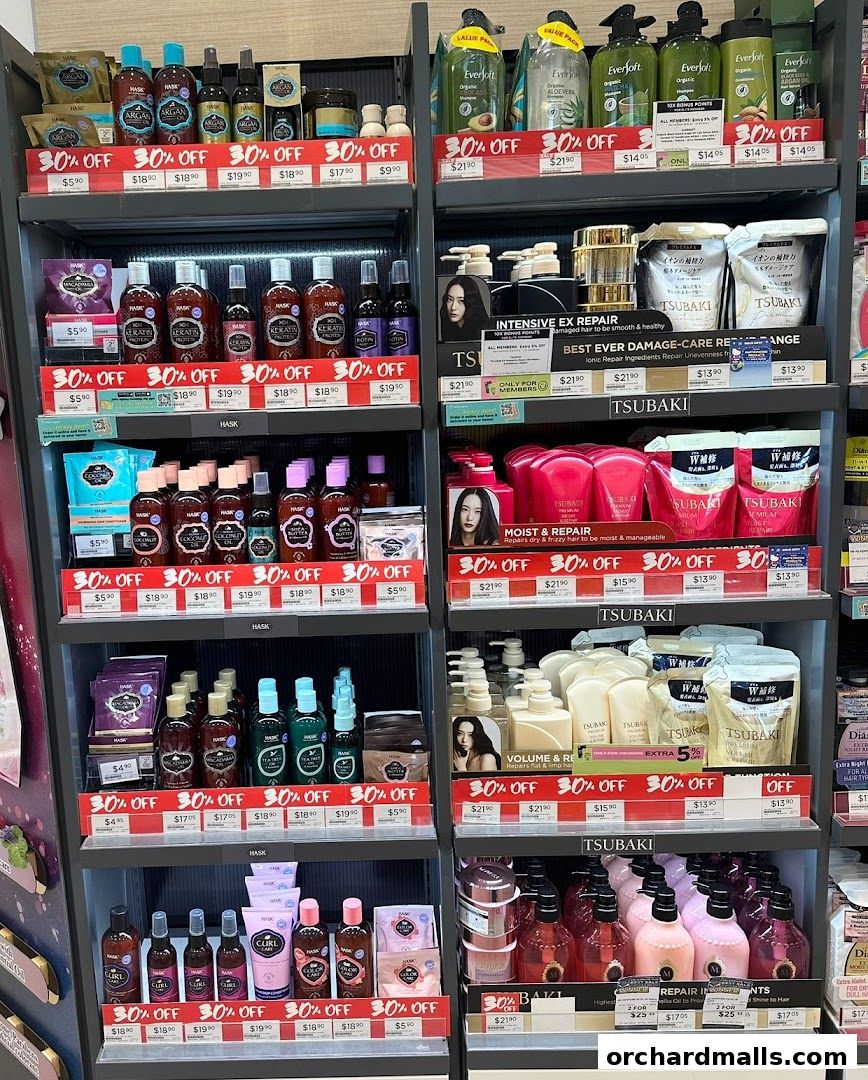 Shelves stocked with various hair care products, including shampoos, conditioners, and treatments, with prominent discount signage.