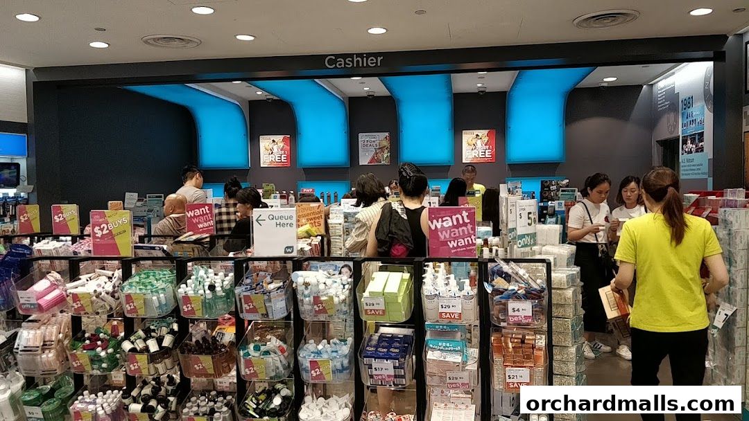 Interior view of a Watsons pharmacy with various products displayed and customers at the cashier.
