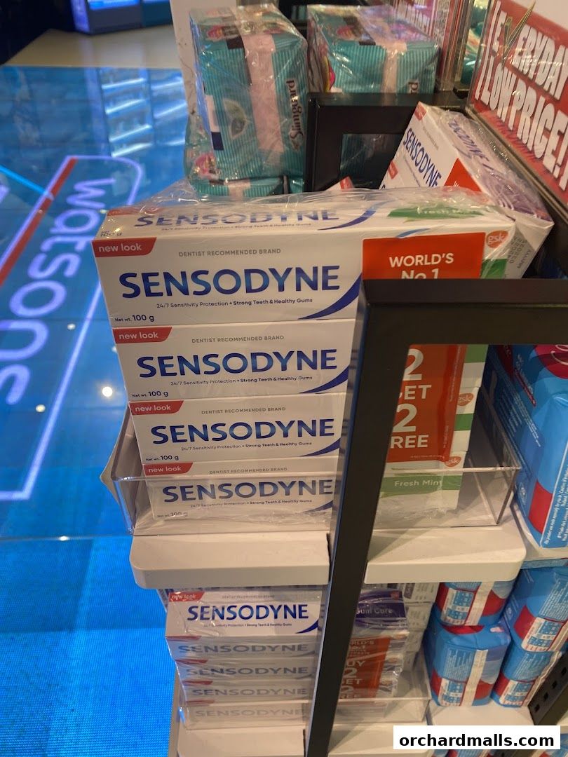 A display of Sensodyne toothpaste boxes and other health products at Watsons.