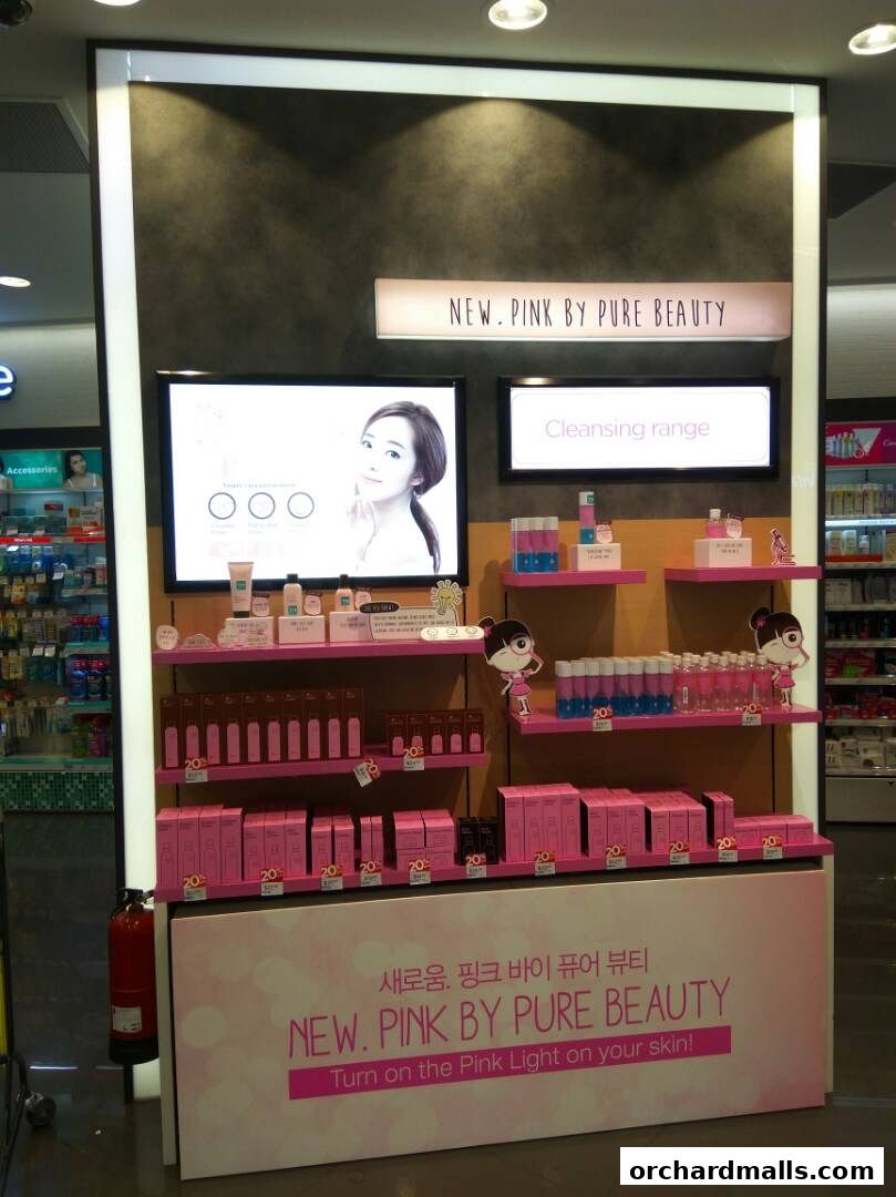A display of 'NEW. PINK BY PURE BEAUTY' skincare products with promotional signage.