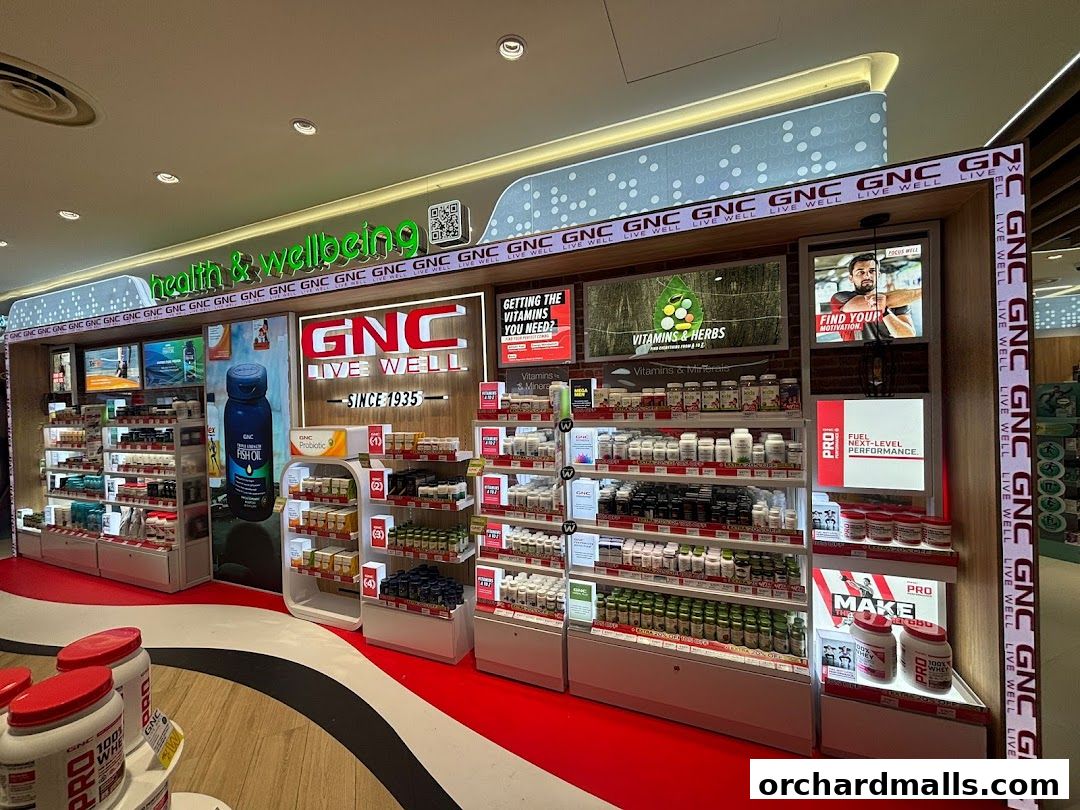 A well-stocked GNC store display featuring vitamins, supplements, and health products.