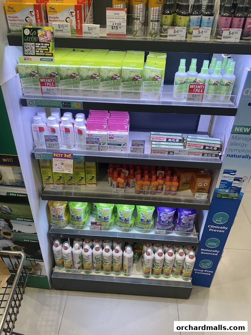 A display shelf in Watsons featuring mosquito repellent patches, sprays, and other health products.