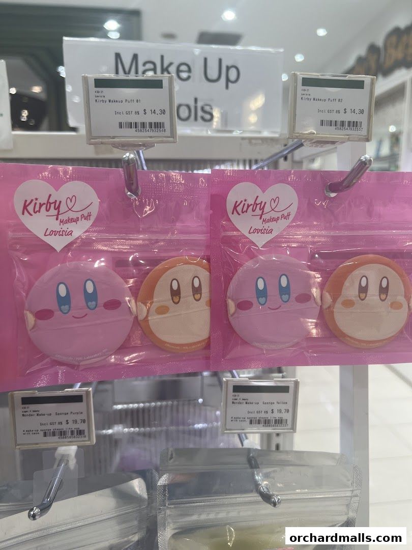 Cute Kirby-themed makeup puffs and sponges displayed on shelves at Welcia.