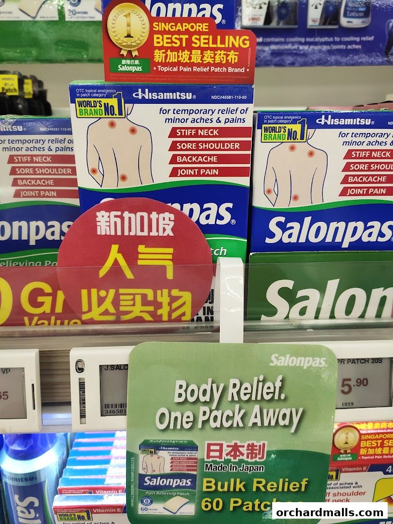 A display of Salonpas pain relief patches with various promotional labels.