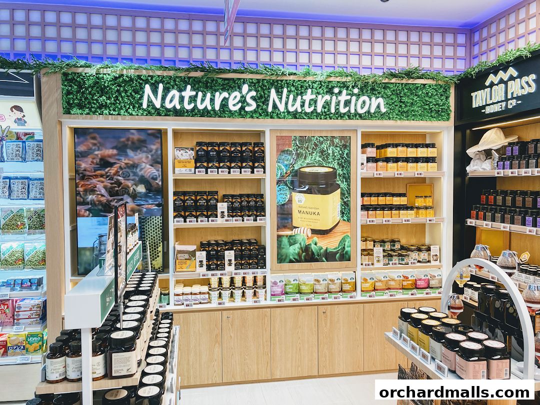A well-stocked shop interior featuring shelves of honey and health products.