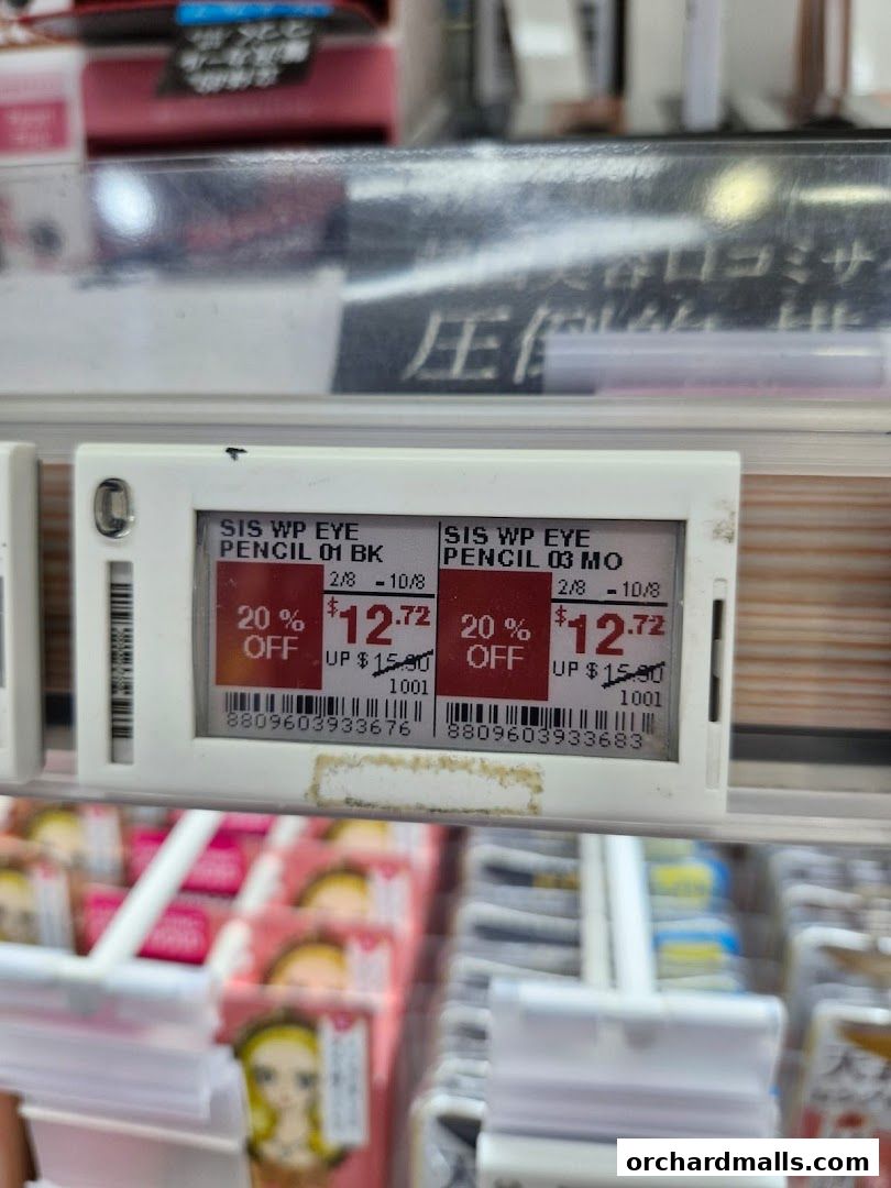 Close-up of electronic price tags showing discounted eye pencils at Welcia.