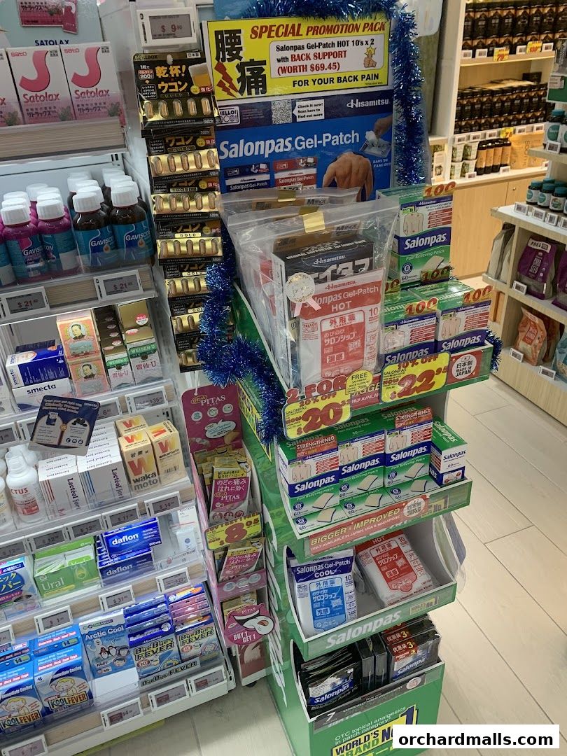 A display stand in a pharmacy featuring various pain relief patches and medications.