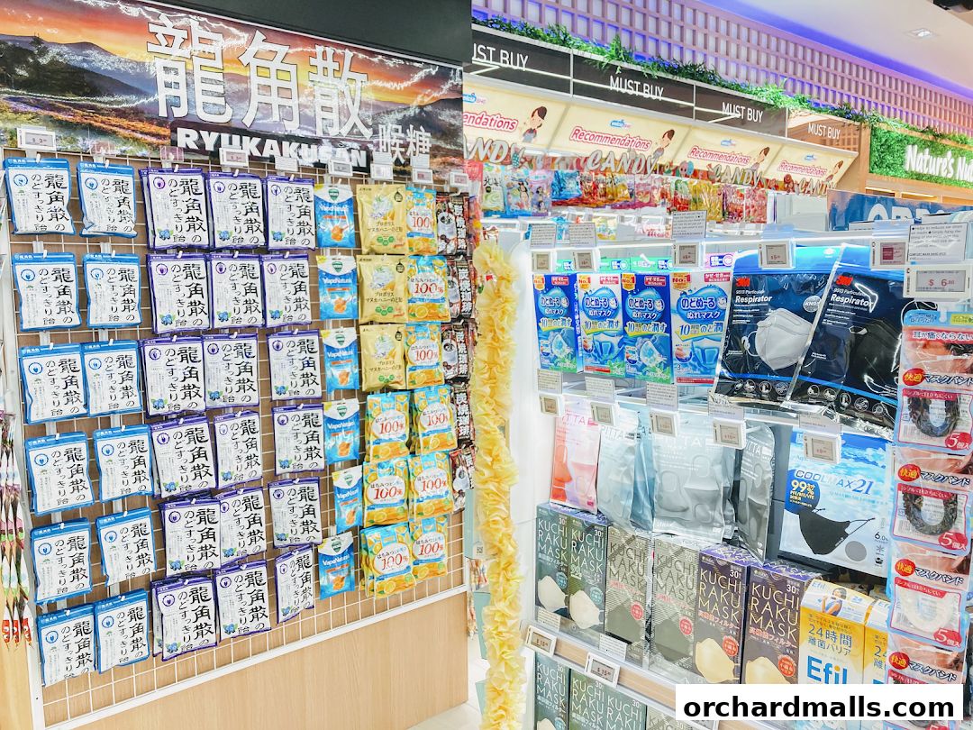 A retail display featuring various health and personal care products, including throat lozenges and face masks.