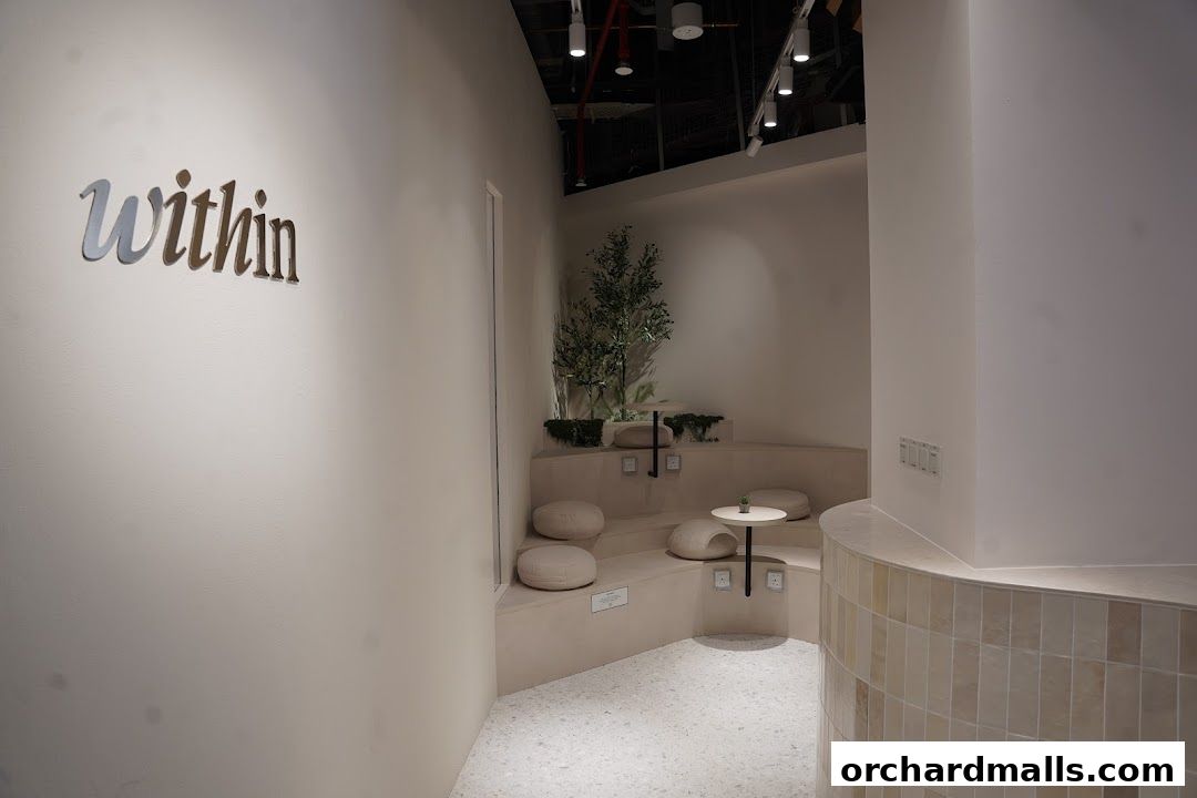 Interior of a modern yoga and pilates studio with a serene seating area.