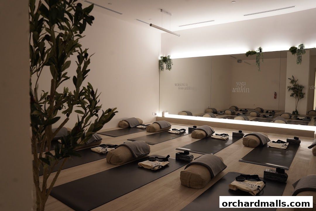 A serene yoga studio with mats, bolsters, and plants, ready for practice.