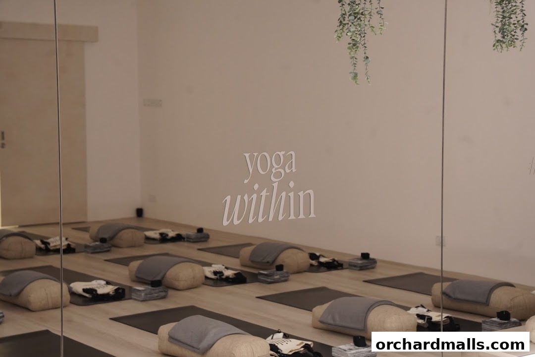 A serene yoga studio with mats, bolsters, and blocks arranged for practice.
