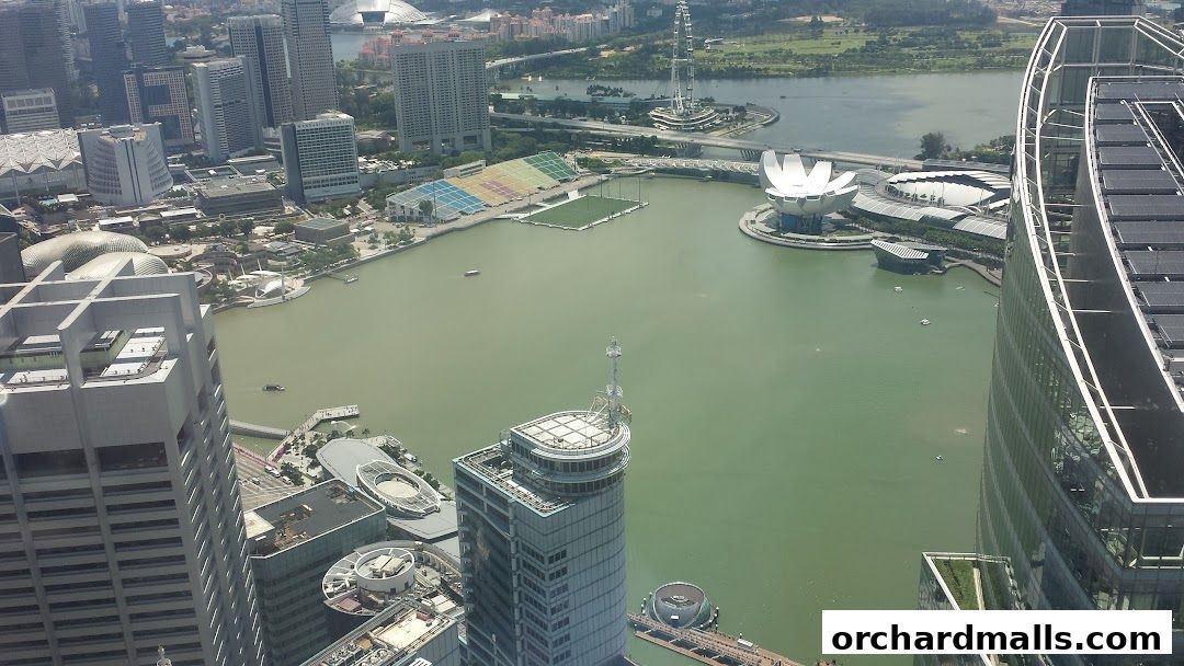 Aerial view of a city skyline with a large body of water and modern architecture.