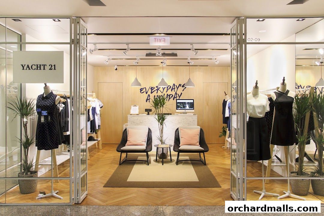 The entrance of the YACHT 21 Wheelock Store, showcasing clothing on mannequins and racks.
