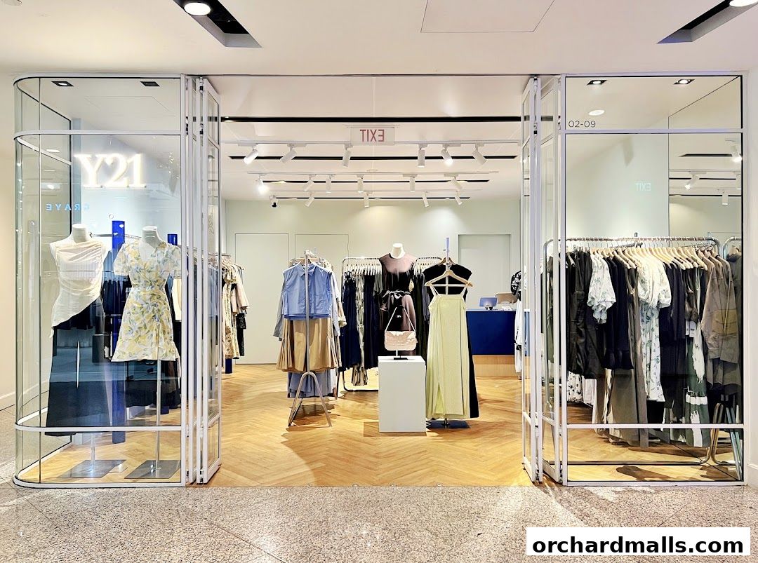 Entrance of Y21 Wheelock Store, showcasing stylish apparel on mannequins and racks.