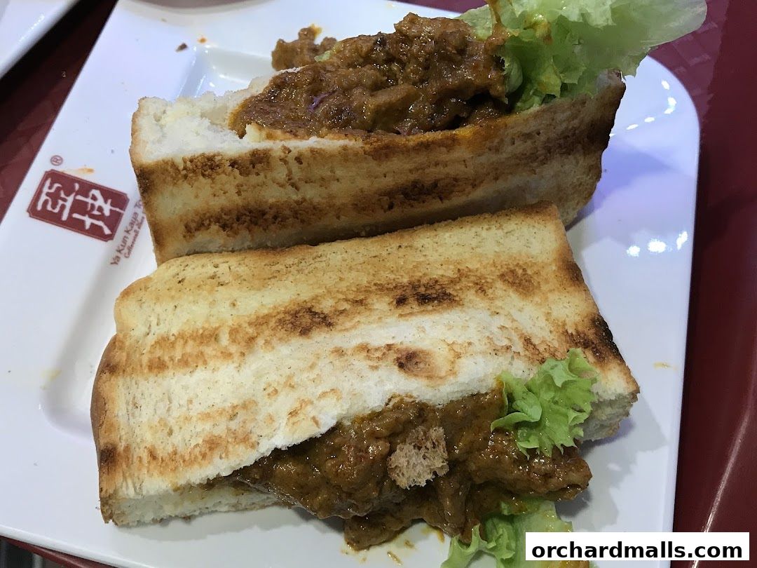 A close-up shot of two halves of a savory sandwich with lettuce and a rich filling.
