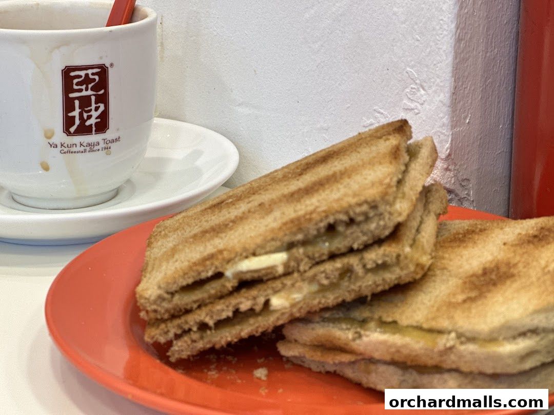 A close-up of Ya Kun Kaya Toast's signature kaya toast and coffee.