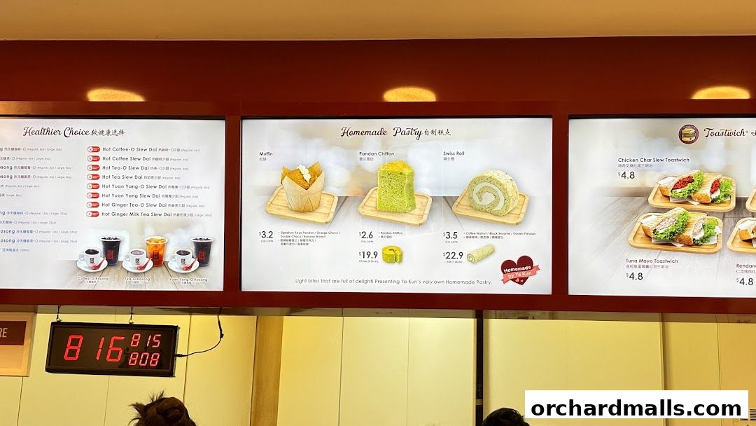 A menu board displaying drinks, homemade pastries, and toastwiches at Ya Kun Kaya Toast.