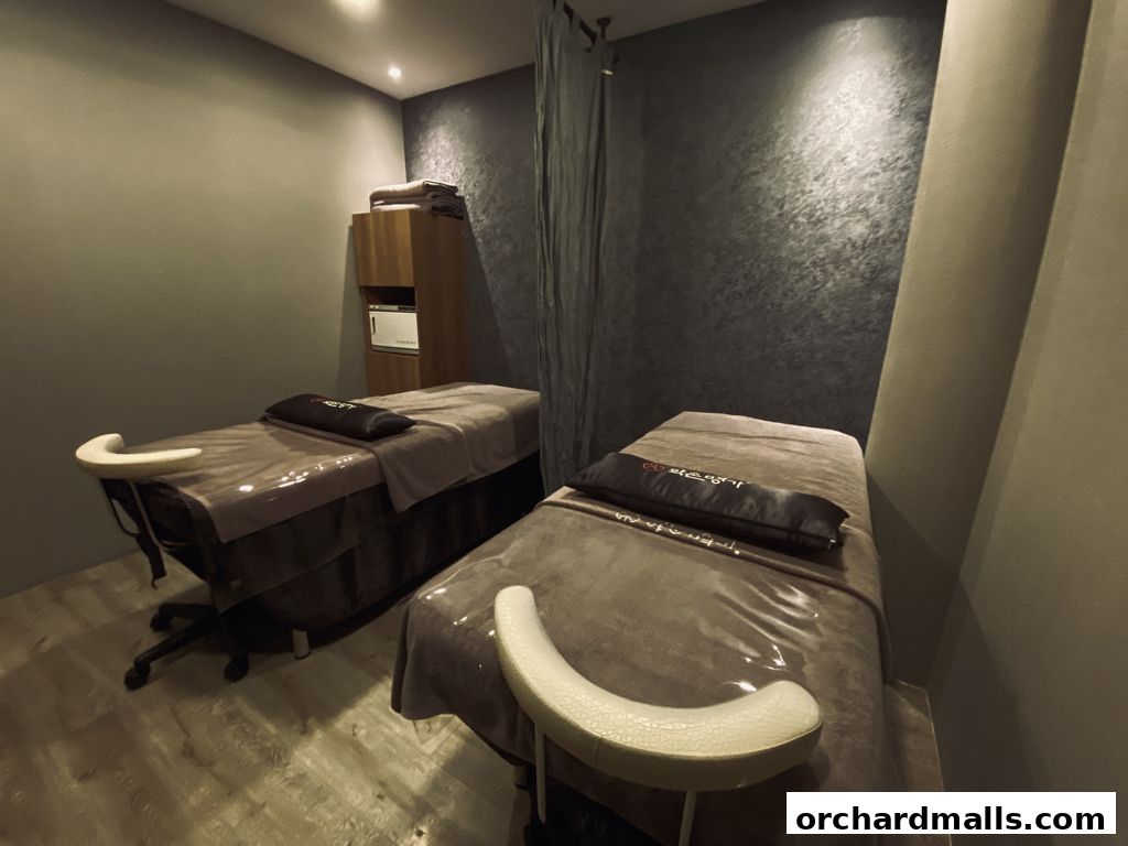 Two massage beds are set up in a clean, modern spa room.