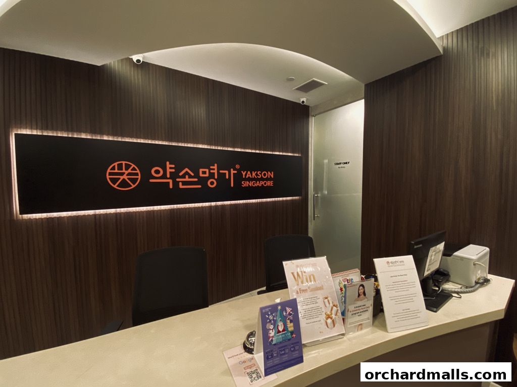 Reception area of Yakson Wheelock Place with a prominent sign and brochures.