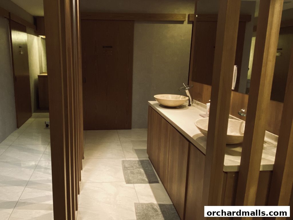 Interior view of a spa or salon with sinks and wooden partitions.
