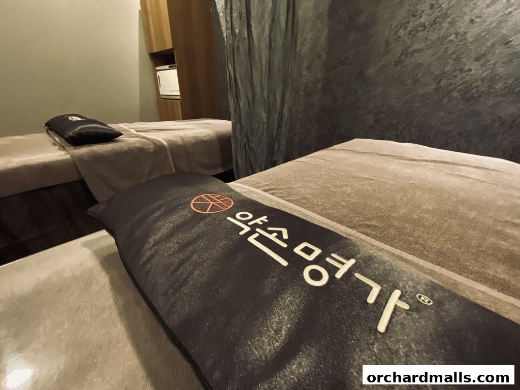 Two massage beds with pillows featuring the Yakson logo and Korean text.