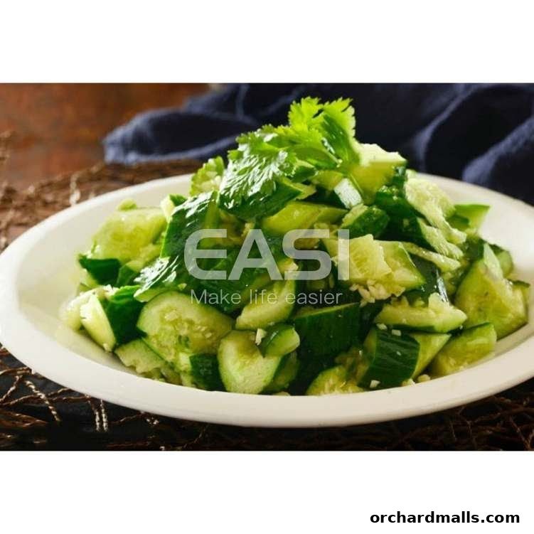 A close-up of a refreshing cucumber salad with fresh herbs on a white plate.