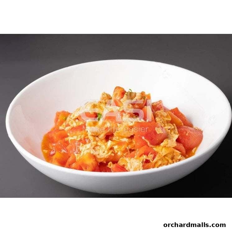 A white bowl filled with a savory dish of scrambled eggs and tomatoes.