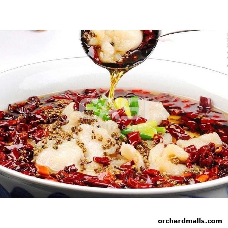 A close-up shot of a steaming bowl of spicy fish dish with chili peppers and Sichuan peppercorns.