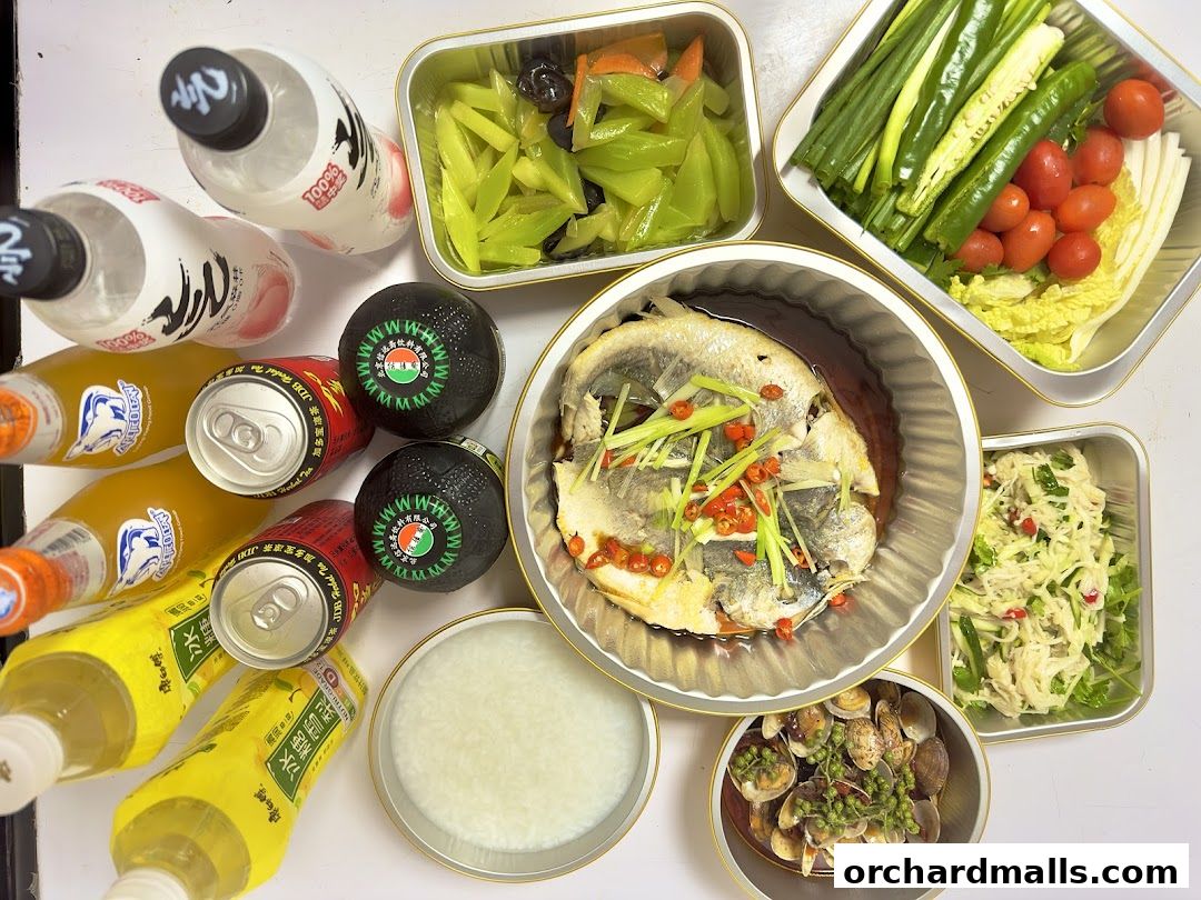 A spread of delicious Chinese dishes including steamed fish, clams, and various vegetables, with drinks.