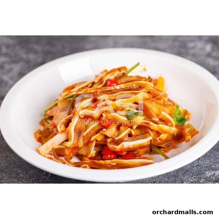 A white bowl filled with sliced, spicy, and savory pork ear salad.