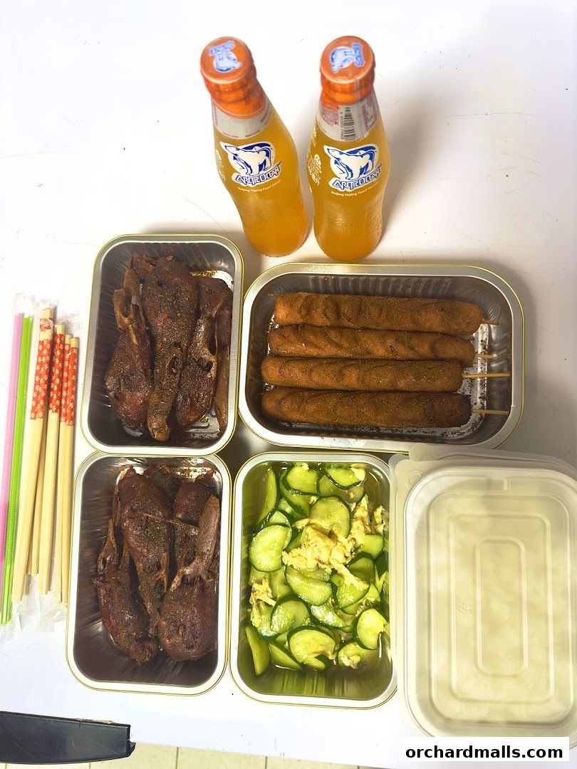 A spread of grilled meats, skewers, cucumber salad, and drinks.