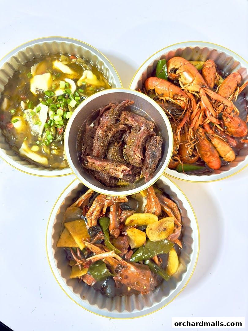 Three dishes of Chinese food, including crawfish, duck, and fish, are presented.