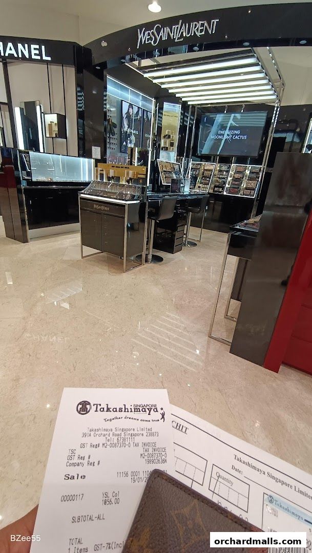 Interior view of a YSL Yves Saint Laurent Beauté shop with displays and a receipt.