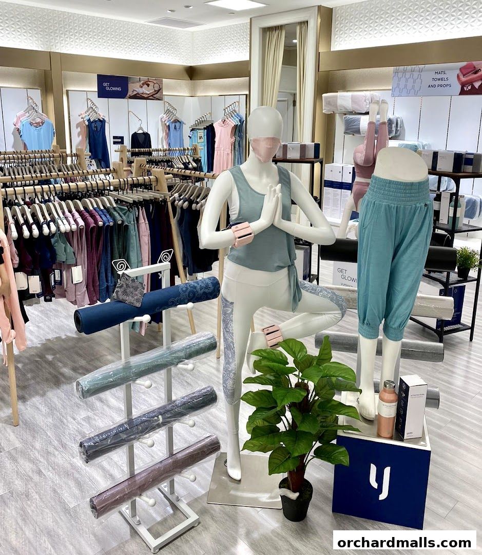 Interior of a Yumi Active store showcasing yoga apparel and accessories with mannequins.