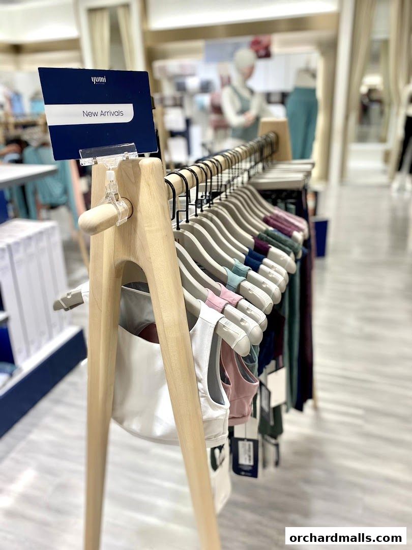 A display of new arrival activewear, featuring sports bras and leggings on hangers.