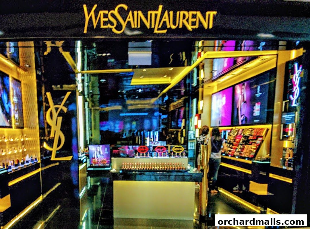 The luxurious Yves Saint Laurent Beaute shop front displays a wide array of makeup products.