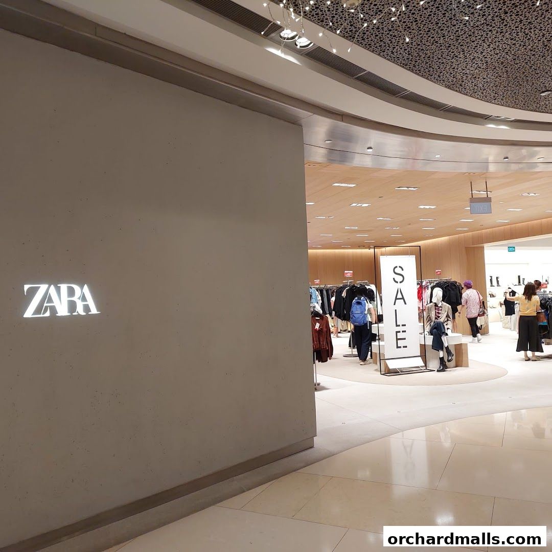 The Zara store entrance with a prominent "SALE" sign and shoppers inside.