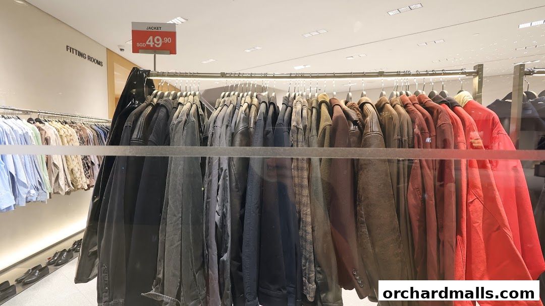 A rack of jackets and shirts in a clothing store, with a price tag for a jacket.