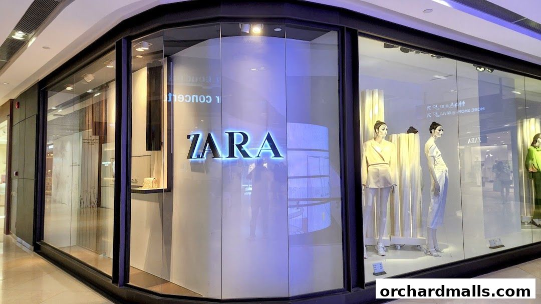 The Zara store entrance with mannequins displaying fashion in the window.