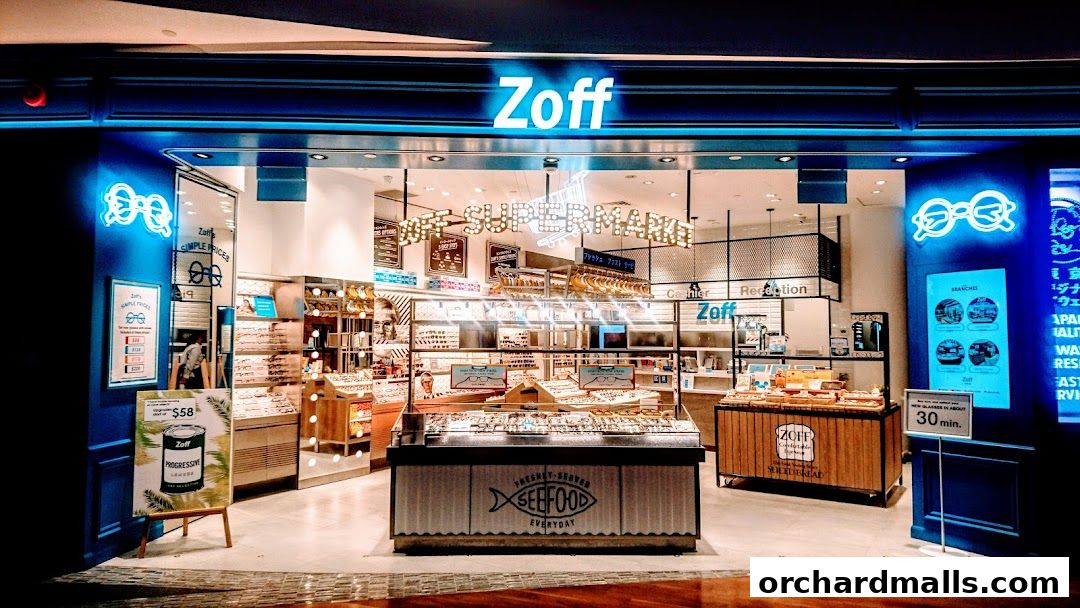 The Zoff store features a bright, modern interior with a wide selection of eyeglasses displayed.