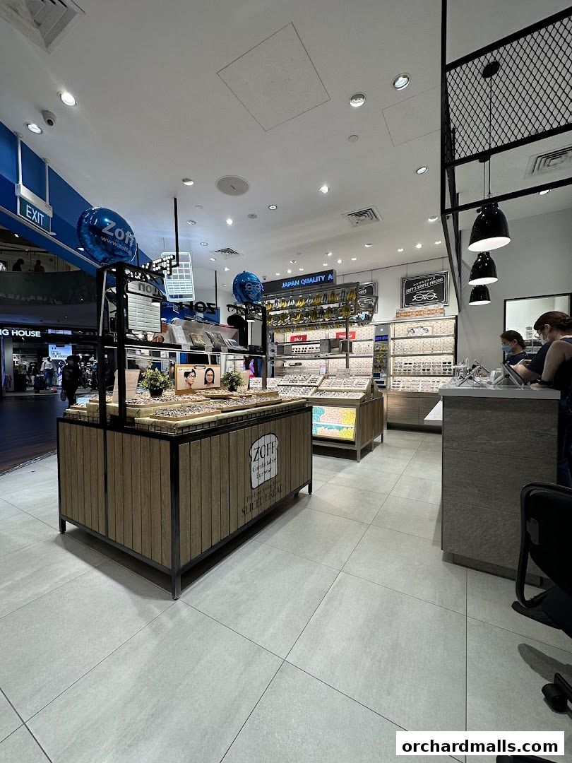 Interior view of a Zoff optical shop showcasing various eyewear displays and a customer service counter.