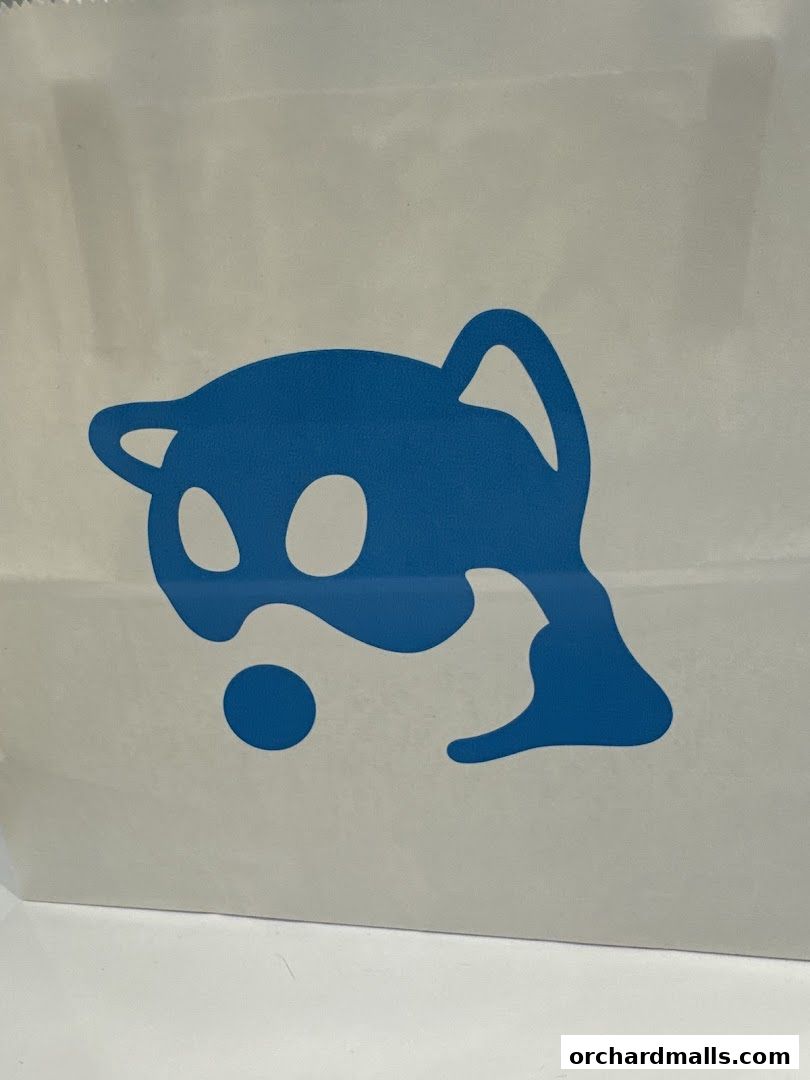 A white shopping bag with a blue cartoon character logo.
